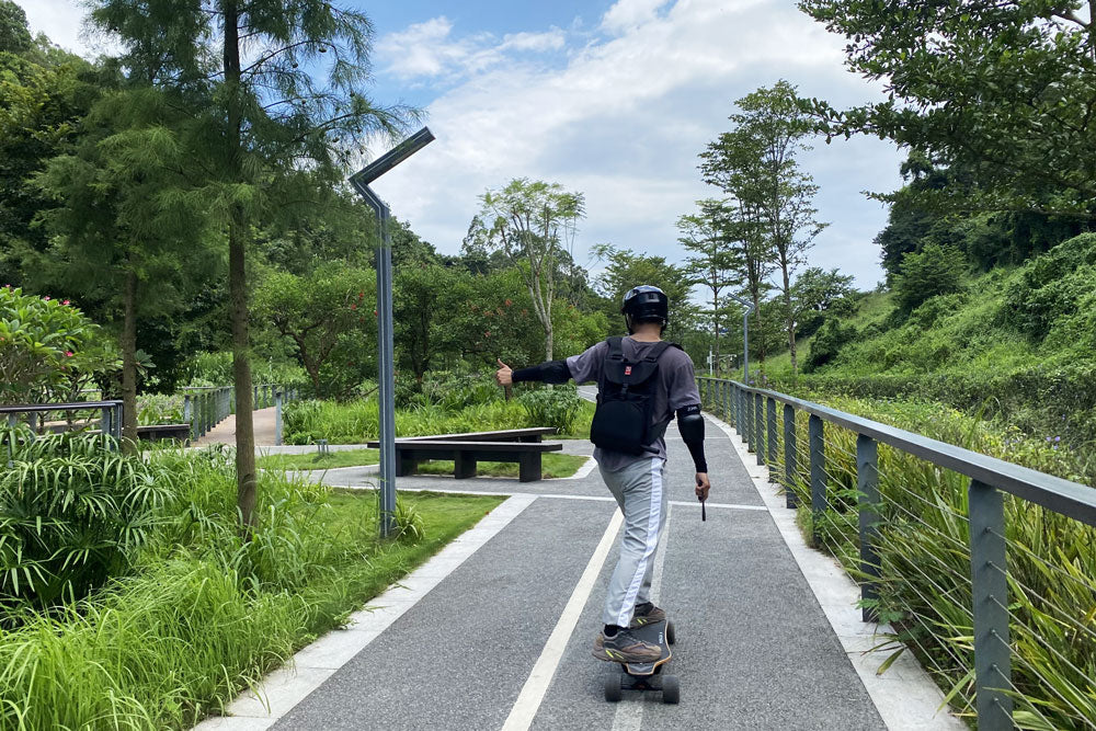 riding a veymax electric skateboard